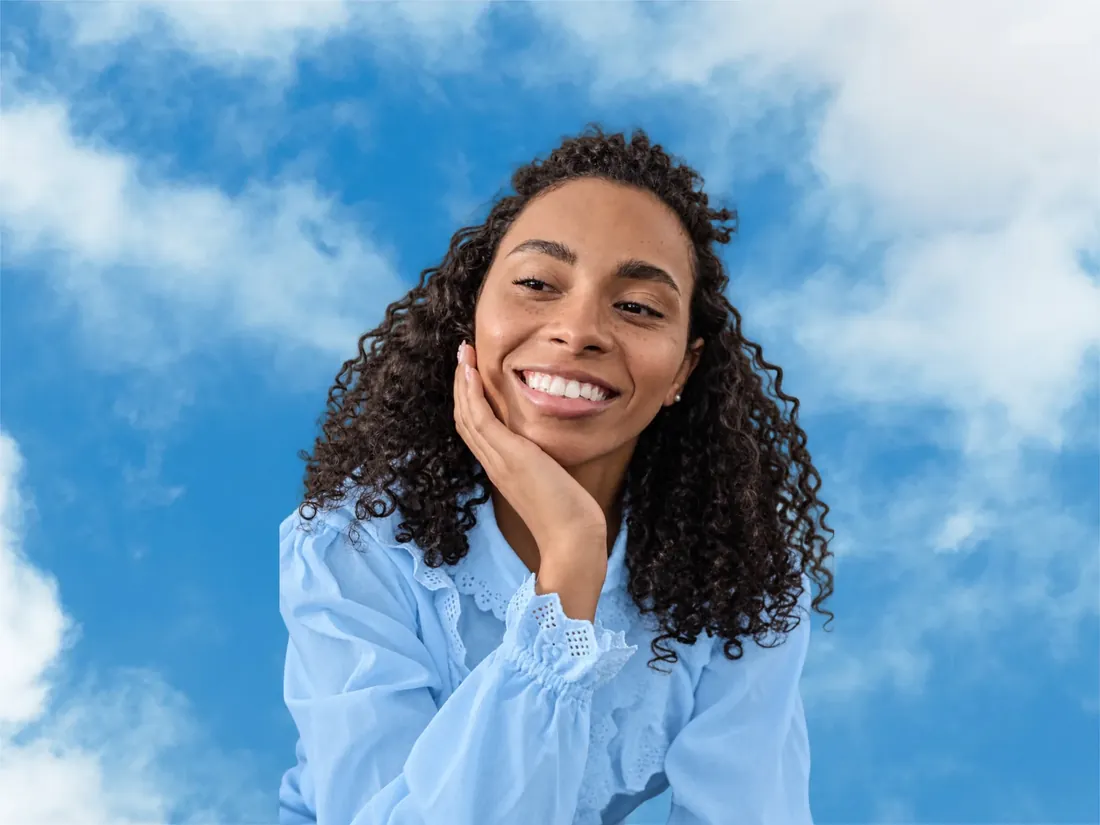 Smiling woman in a baby blue blouse