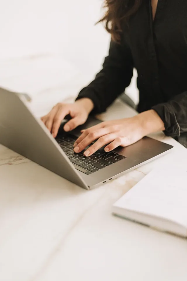 Person typing on a laptop