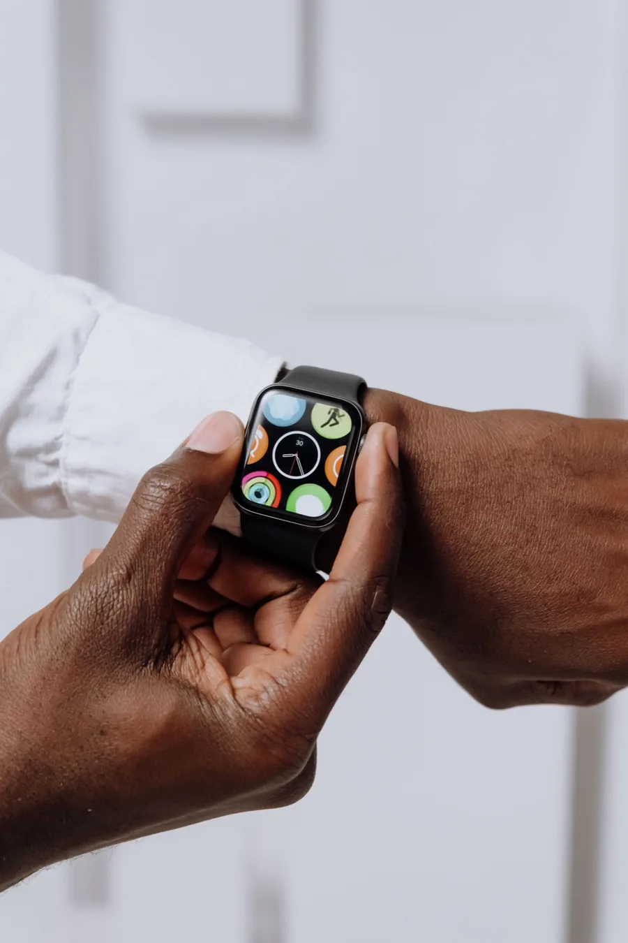 Person checking step and activity progress on a smartwatch